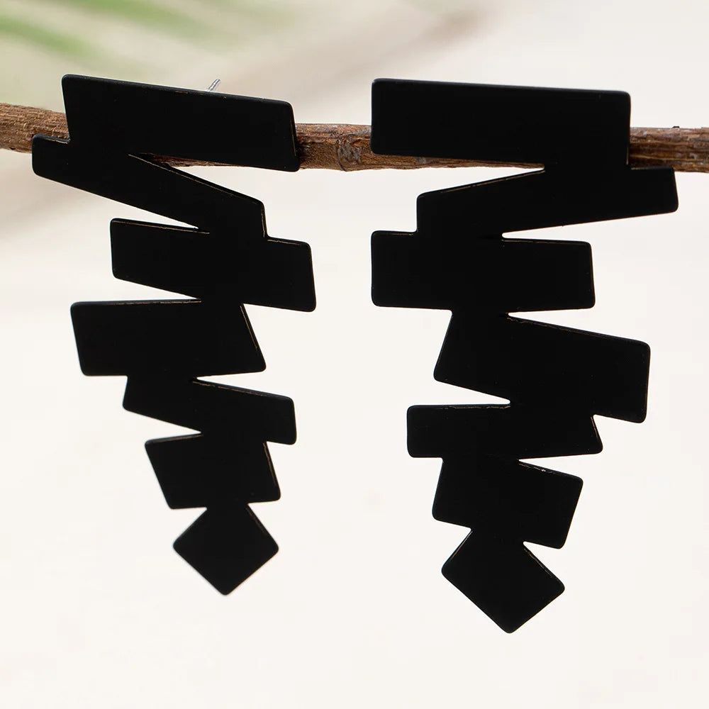 Geometric stud earrings in black with layered zigzag blocks and a pointed tip