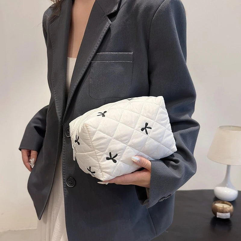 White quilted cosmetic bag with bow embroidery and zip closure