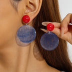Red ball stud drop earrings with translucent blue round discs and silver-tone hanging hooks
