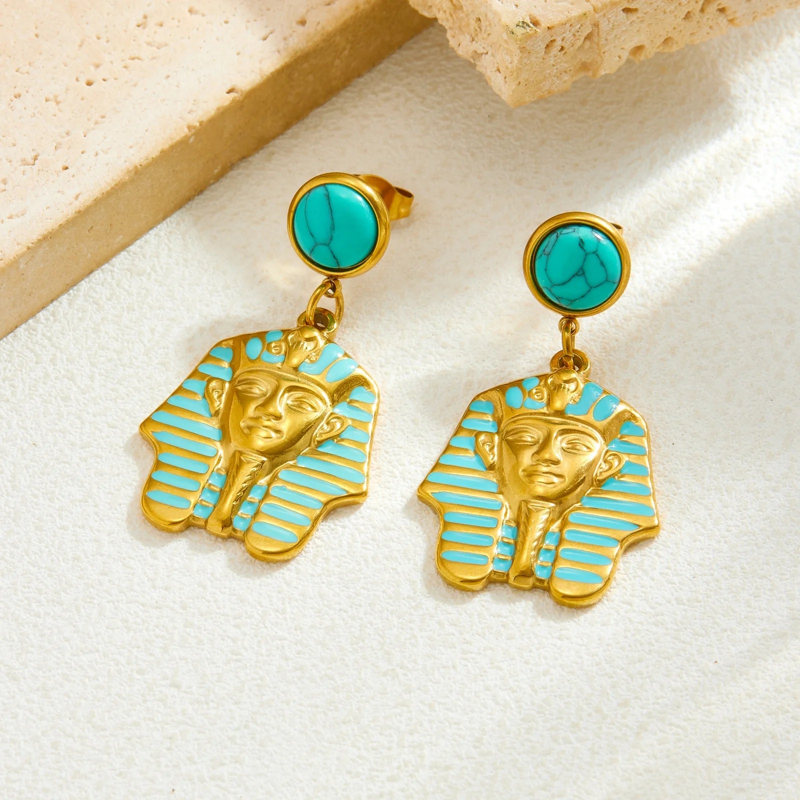 Turquoise stud earrings with gold pharaoh face and blue striped enamel dangle charms