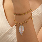 Gold double-layer chain bracelet with leaf charm and small bead accents