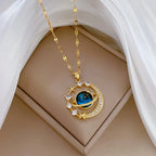 Gold-tone planet pendant necklace with blue globe, halo stones, and star charm