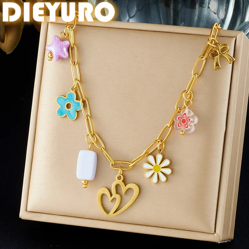 Gold enamel pendant necklace with heart charm and pink, blue, and white flower pendants