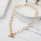 Gold-tone oval link chain collar necklace with heart clasp and bar charm