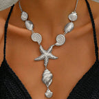 Silver shell and starfish pendant necklace with spiral discs, scallop shells, and hanging charm