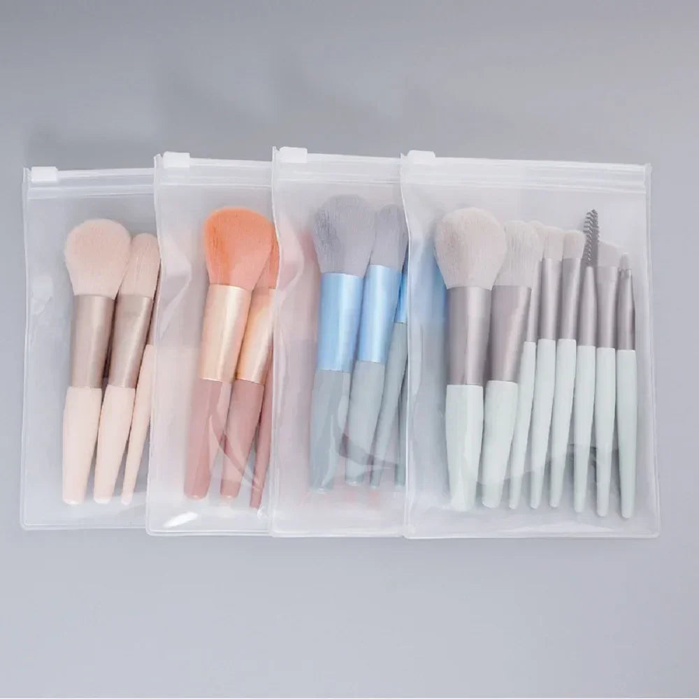 Makeup brush set in clear organizer, pale brushes with orange, blue, and white bristles