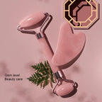 Facial massage roller with pink stones and silver metal U-frame, handheld beauty tool