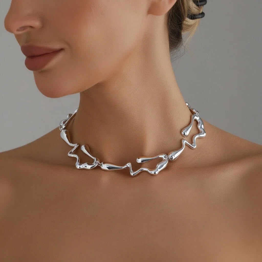 Silver-tone lava drip choker necklace worn with matching drop earrings