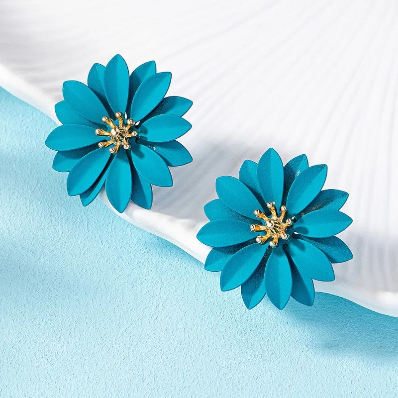 Teal blue enamel flower stud earrings with gold-tone starburst centers