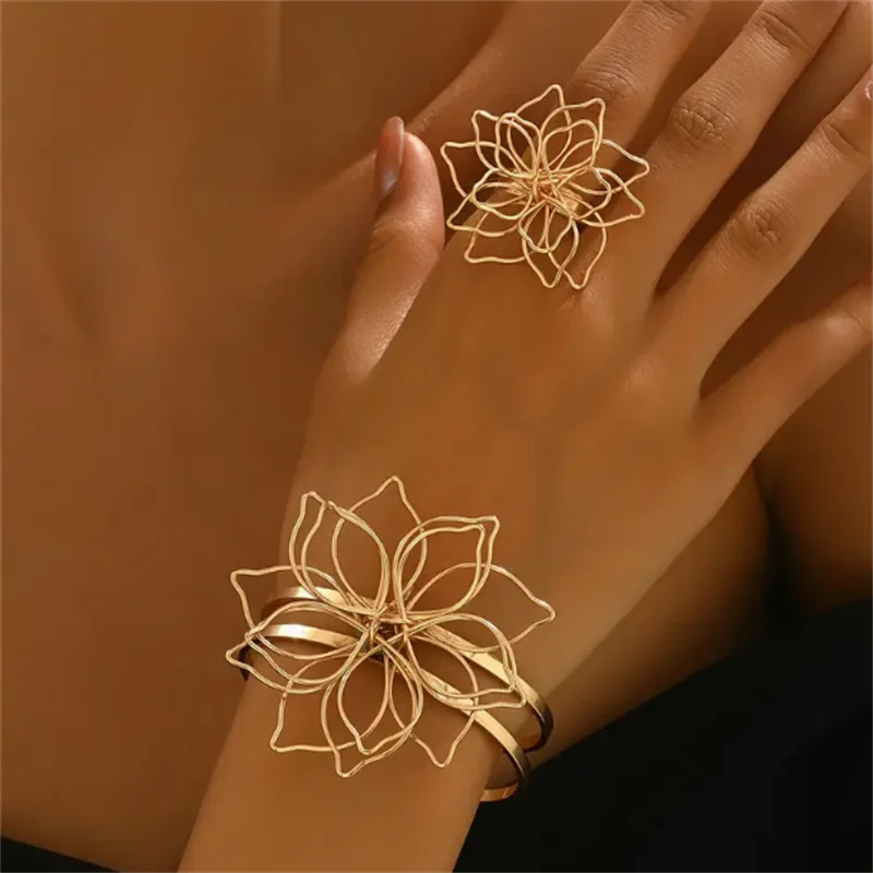 Gold hollow flower ring and cuff bracelet set, layered openwork petals on fingers