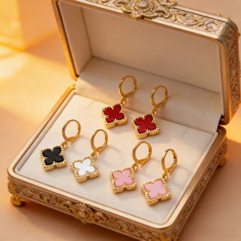 Four-leaf clover dangle earrings in gift box, showing red, black, white, and pink clovers