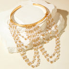Gold-tone upper arm bracelet with pearl bead chains and scalloped cuff band
