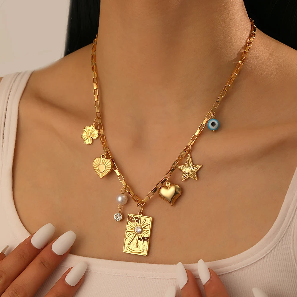 Gold-tone charm necklace with heart, star, square pendant, pearl and zircon details