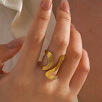 Gold-plated open stacking geometric ring set on hand, close-up