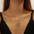 Gold chain pendant necklace with blue enamel starfish flower charm