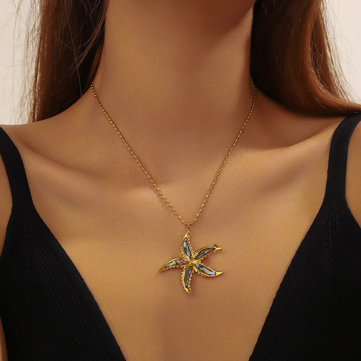 Gold chain pendant necklace with blue enamel starfish flower charm