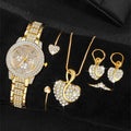 Gold watch with rhinestone bezel and bracelet; heart necklace, dangling earrings, and rings