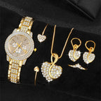 Gold watch with rhinestone bezel and bracelet; heart necklace, dangling earrings, and rings