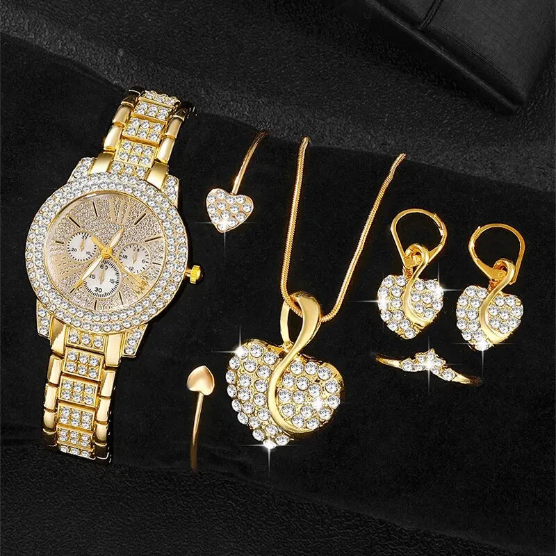 Gold watch with rhinestone bezel and bracelet; heart necklace, dangling earrings, and rings