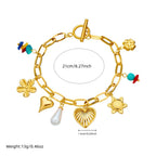Gold-tone charm bracelet with pearl drop, flower and shell charms, turquoise accents, 21cm