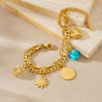 Gold-tone double-layer bracelet with heart charm, coin charm, sun charm and turquoise bead