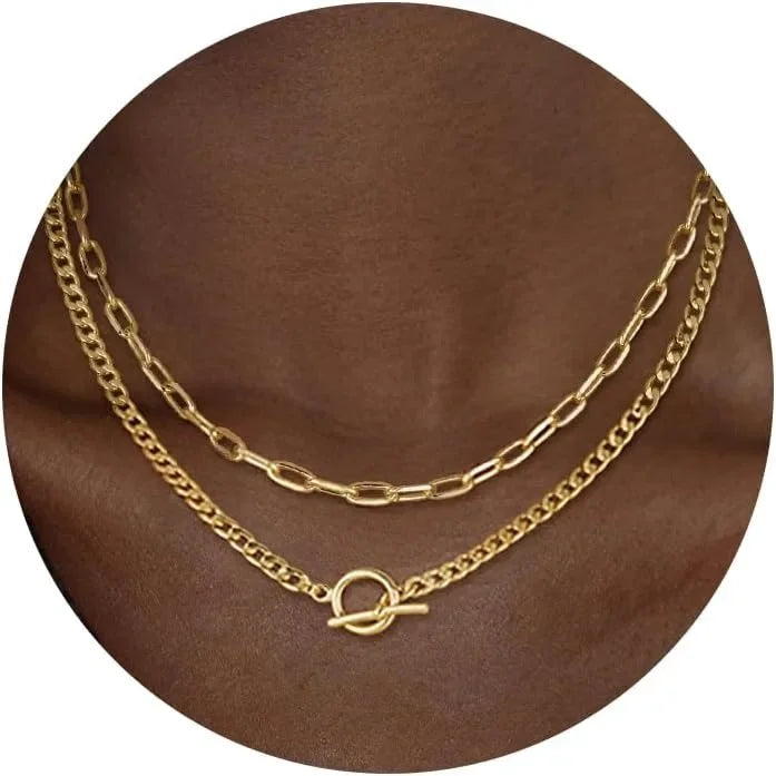 Gold layered chain necklace with oval connector and two stacked chain links