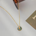 Gold-tone chain necklace with round painted flower pendant and loop bail