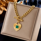 Gold-tone heart pendant necklace with green square stone heart charm and toggle clasp