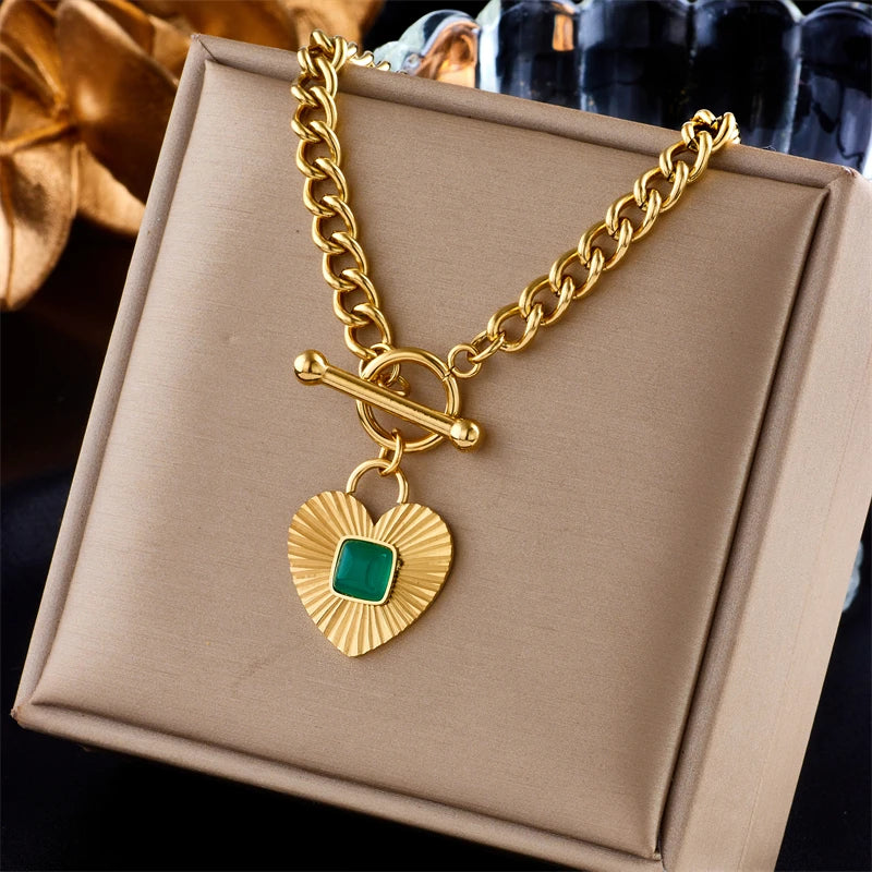 Gold-tone heart pendant necklace with green square stone heart charm and toggle clasp