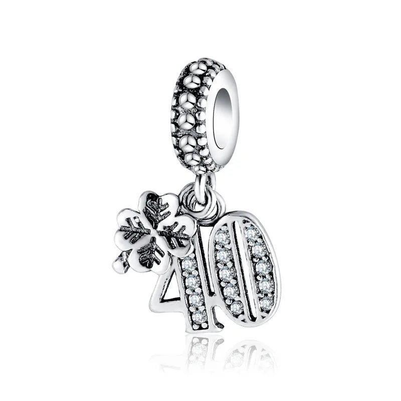 Dangle charm bead with decorative ring top, snowflake detail, and letter-style pendant