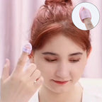 Pink teardrop finger puff sponge dabbing near the under-eye area.