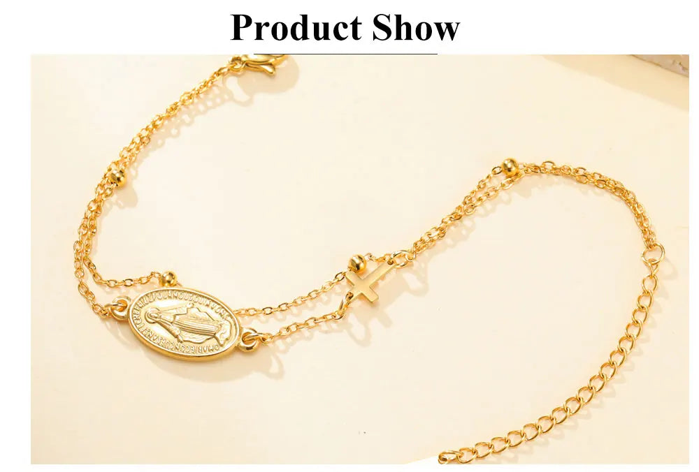 Gold-tone oval pendant bracelet with Virgin Mary medallion and cross charm on chain