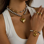 Layered ball-bead heart necklace with gold heart pendant, ring, and charm bracelet