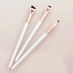 Eyeliner and eyebrow makeup brushes, three white handles with copper bristle tips