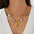 Gold-tone necklace with octopus charm and blue enamel shell drop, on chain links.