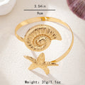 Gold shell disk and starfish arm cuff with ridged disk and raised starfish detail