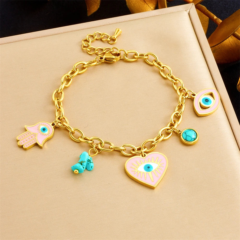 Gold-tone charm bracelet with heart evil-eye pendant, blue eye, and turquoise beads