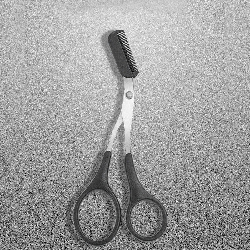 Eyebrow scissors with comb, close-up of black comb head and silver blades