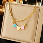 Gold double-layer heart necklace with blue, pink, and white enamel heart charms