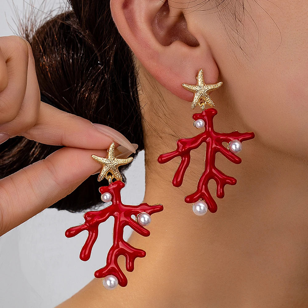 Coral starfish earrings in red enamel with gold-tone starfish tops and pearl-like accents