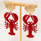 Gold-tone lobster dangle earrings with red lobster charms and scallop shell stud tops