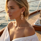 Pearl shell drop earrings with gold-tone seahorse charm, dangling design