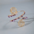 Gold-tone upper arm bracelet with spiral charm and purple and clear stone bead strands
