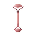 Pink facial massage roller with dual oval heads and curved handle