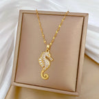 Gold-tone seahorse rhinestone pendant necklace on square display box