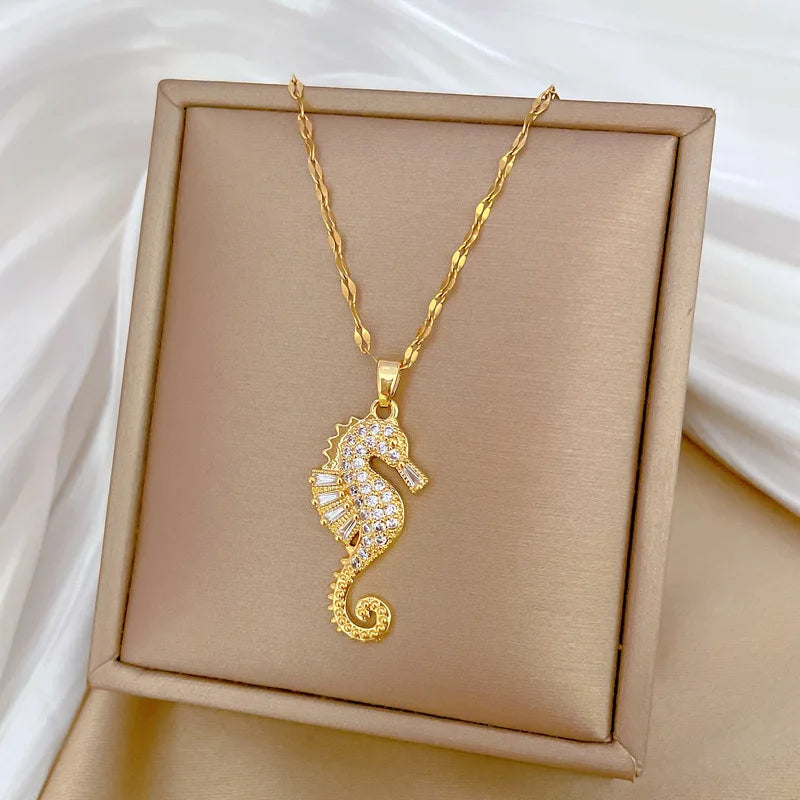 Gold-tone seahorse rhinestone pendant necklace on square display box