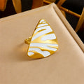Tiger stripe teardrop ring, white enamel with gold-tone edge and black stripes