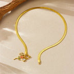 Gold-tone snake chain necklace with rose and red enamel heart charm