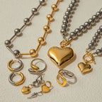 Heart pendant necklace with gold heart charm and silver bead chain, plus matching rings