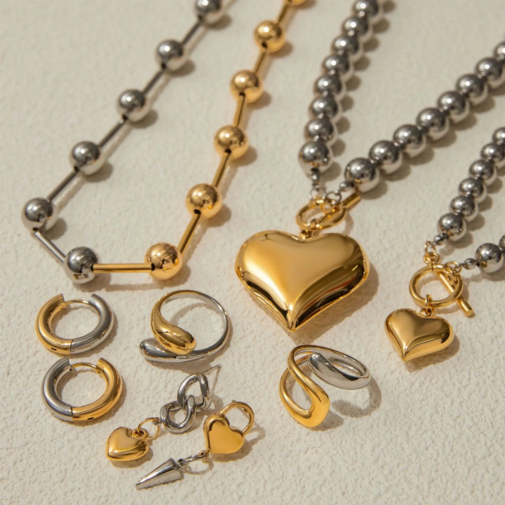 Heart pendant necklace with gold heart charm and silver bead chain, plus matching rings